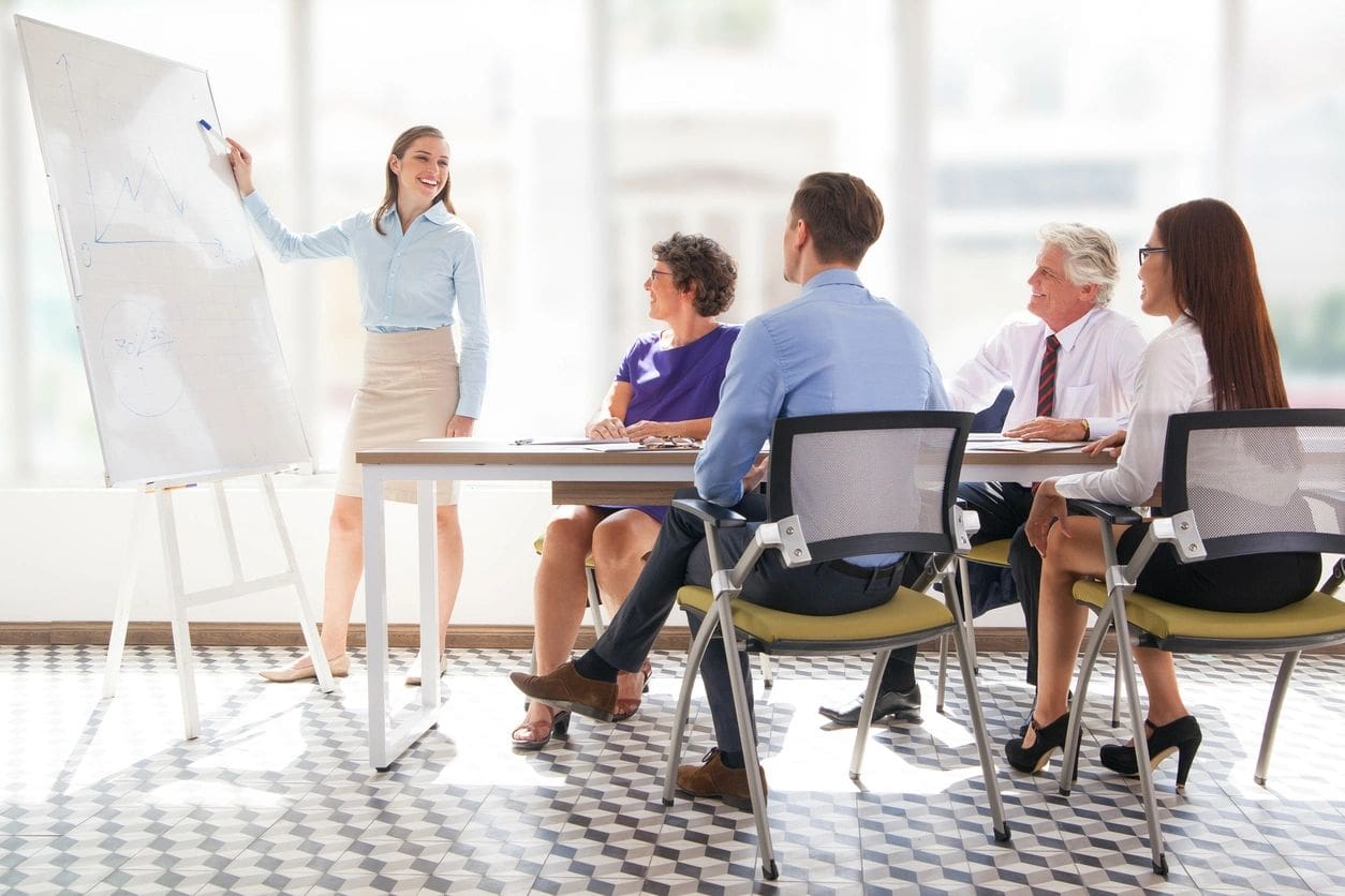 A woman standing in front of a group of people.