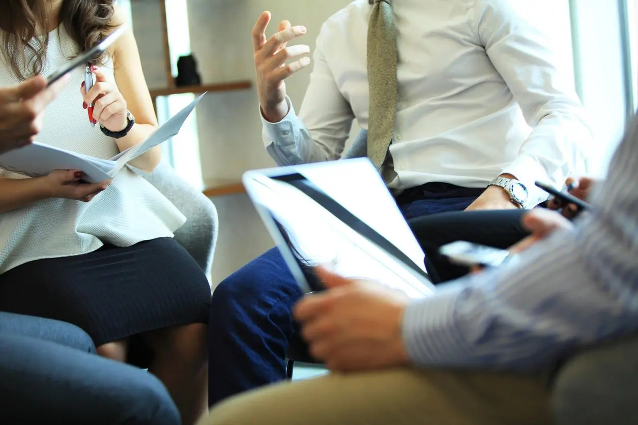 A group of people sitting around each other.